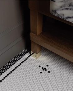 a bathroom floor with black and white dots on it