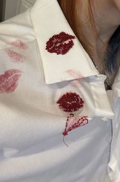 a woman with red lipstick on her shirt