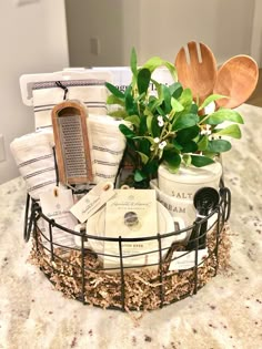 a basket filled with lots of items on top of a kitchen counter next to a potted plant