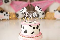 there is a cake decorated with black and white polka dots