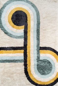 a white rug with blue, yellow and black circles on it's edges in the shape of a letter p