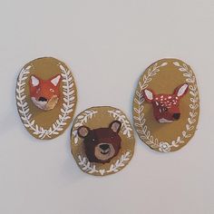 three animal magnets are hanging on the wall