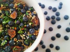 a white bowl filled with blueberries and other food items on top of a table