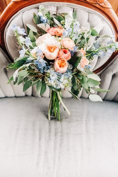 a bouquet of flowers sitting on top of a chair