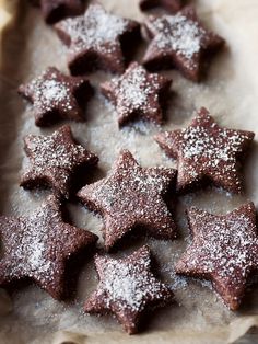 some brownies with powdered sugar are on a baking sheet and ready to be eaten