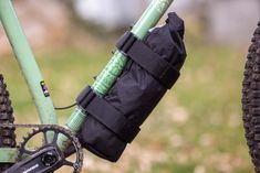 the handlebars and seat bag are attached to the rear end of a bike