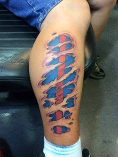 a man's leg with an american flag tattoo on his thigh and the word america written in red, white and blue