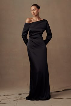 Exude elegance.The AVERY Long Sleeve Maxi Dress features an asymmetrical drop shoulder neckline, adding modern sophistication. With long sleeves for coverage and grace, it boasts side gathered waist detailing for a touch of femininity. Lined for comfort, this dress ensures you look and feel your best for any elegant occasion. Off The Shoulder Black Dress Long Sleeve, Black Tie Event Dresses Long Sleeve, Dress For Christmas Wedding Guest, Elegant Black Dress With Sleeves, Black Tie Wedding Guest Dress With Sleeves, Long Sleeve Black Maxi Dress Formal, One Shoulder Dress Long Sleeve, Long Christmas Dresses, Black Bridemaid Dress