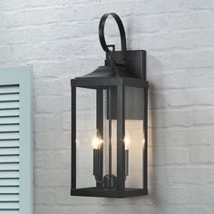 an outdoor wall light with three lights on it