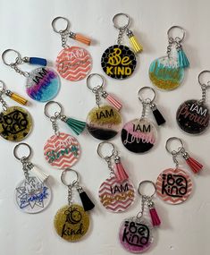 a bunch of key chains that have different designs on them with the words i am so kind