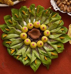 an arrangement of fruits and vegetables are arranged on a red tablecloth with other food items