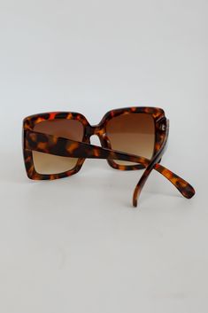 Top off any look with the Turn Up The Sunshine Tortoise Oversized Square Sunglasses to look instantly chic! These essential summer sunglasses have an oversized square shape with tortoise frames! Save your eyes the strain and harmful rays with a pair of sunglasses that never compromise style or function. Oversized Square Shape Tortoise Frames One Size | Frame Length 5.5" | Height 2.25" | Temple Arm Length 5.75" Tortoise Color, Summer Sunglasses, Turn Up, Square Sunglasses Women, Tortoise, Sunglasses Women, That Look, Square, Sunglasses