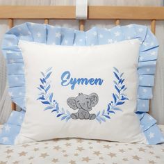 a blue and white pillow with an elephant in the center that says gymn on it