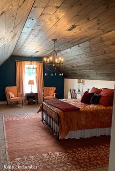 a large bed sitting under a wooden ceiling