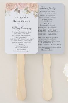 two wooden paddles with flowers on them and the names of their wedding ceremony programs