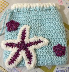 a crocheted bag with a starfish on it