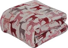 a red and white blanket with an elephant design on the bottom, sitting on top of it