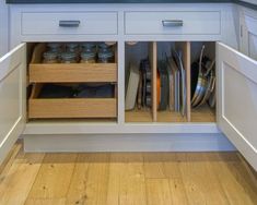 an open cabinet in the middle of a kitchen