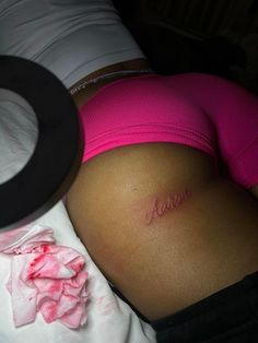 a pregnant woman with her name tattoo on her stomach