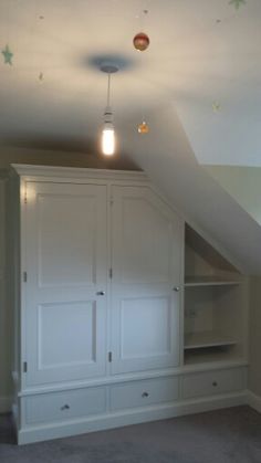 an attic bedroom with built - in closets and painted stars on the ceiling