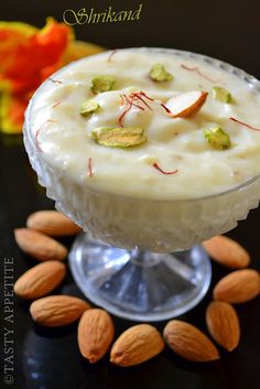 a dessert with almonds and pistachio on the side in a glass dish