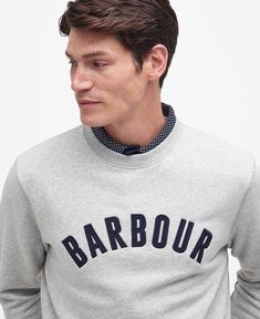 Inspired by classic sportswear, the Barbour Addington Sweatshirt is the perfect way to add a vintage touch to your daily layers. Complete with a varsity-inspired logo to the chest, this piece is the perfect accomplice to jeans and trainers for a day exploring nature. Classic Winter Sweatshirt With Letter Print, Classic Sports Sweatshirt With Ribbed Cuffs, Classic College Sweatshirt With Letter Print, Classic Letter Print Sweatshirt For College, Classic Cotton Sweatshirt With Logo, Classic Cotton Sweatshirt With Letter Print, Casual College Sweatshirt With Logo Detail, Casual College Sweatshirt With Logo, Classic Crew Neck Sweatshirt With Logo Print