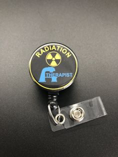 This unique retractable badge holder is adorable and useful. A great gift for any Radiation Therapist! These will be made with a belt clip back. If you prefer a swivel clip, let me know in the notes to seller section when checking out. Thank you!! :) Black Retractable Badge Holders As Gift, Black Retractable Badge Reel For Gift, Adjustable Black Retractable Badge Holder, Black Adjustable Retractable Badge Holders, Black Badge Reel With Swivel Clip As A Gift, Radiation Therapist Gifts, Radiation Therapist, Xray Tech, Retractable Badge Holder