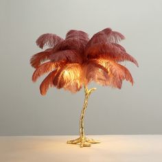 a lamp that is on top of a table with a plant in it's center