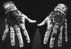 two hands with tattoos on their palms