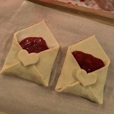 two pastries sitting on top of a piece of wax paper next to each other