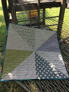 a quilt is laying on top of a hammock