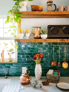 the kitchen counter is covered with pots and pans, plates, cups, and utensils