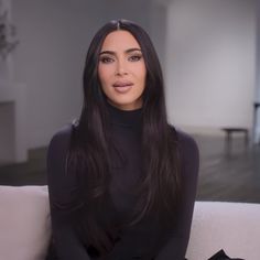 a woman sitting on top of a white couch