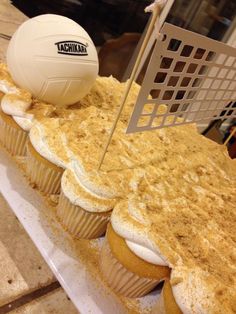 there is a volleyball on top of cupcakes