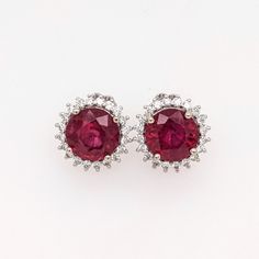 Add a touch of elegance and sophistication to any outfit with these fabulous red ruby studs in 14k white gold. With a sparkling diamond halo and a classic round shape, these studs are the perfect July birthstone accessory. Crafted in solid gold, these statement studs are a timeless addition to any jewelry collection.