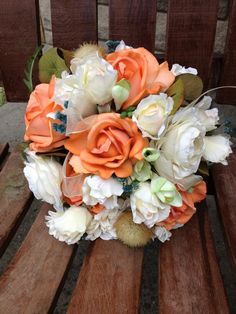 a bridal bouquet sitting on top of a wooden bench