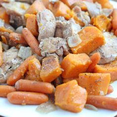 a white plate topped with carrots and meat