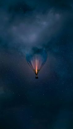 a hot air balloon flying through the night sky