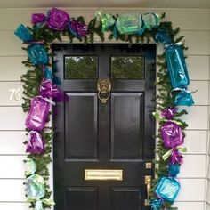 a black door with purple and green decorations on it