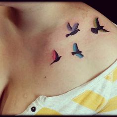 a woman's stomach with small birds on her chest and the word love written in black ink