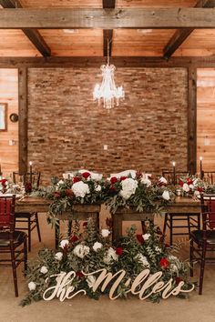 the table is set up with flowers and greenery for an elegant wedding reception at this rustic venue