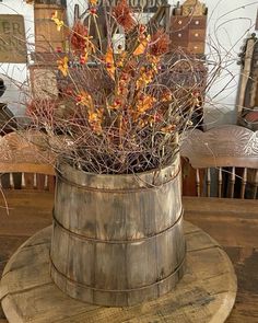 a wooden bucket filled with branches on top of a table