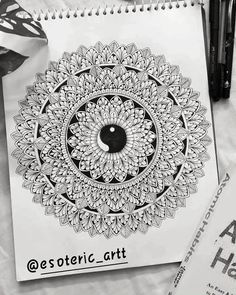 a spiral notebook sitting on top of a table next to some pens and paper with the words estetotic art written in it