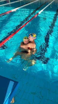 a man swimming in a pool with goggles on