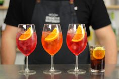 three glasses filled with different types of drinks