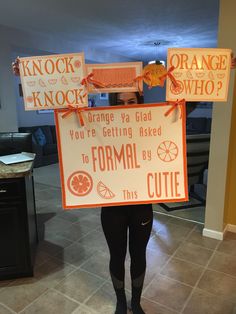 a woman holding up a sign that says orange is the new black