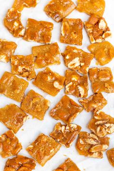 pieces of food sitting on top of a white tablecloth covered in brown and yellow squares