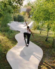 a man riding a skateboard up the side of a cement ramp in a park