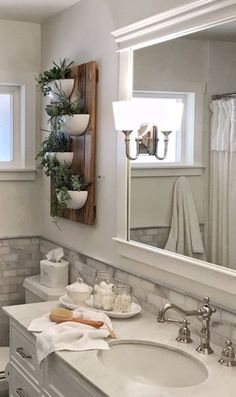 a bathroom with a sink, mirror and towel rack on the wall in front of it