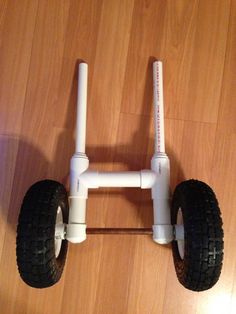 a white toy car sitting on top of a wooden floor